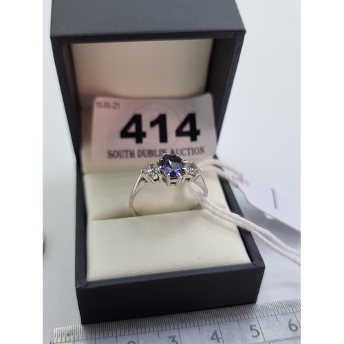 414 - A very pretty 9 carat white gold three stone tanzanite ring. Weight 3g, size Q 1/2.