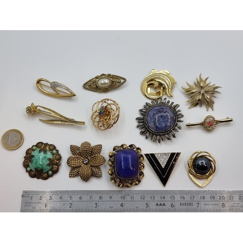 47 - A collection of 13 brooches, including Victorian and Art deco examples.