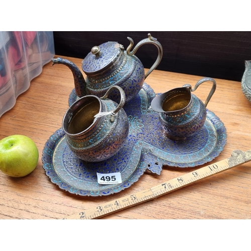 495 - A Persian tea set including a tea pot, a serving jug and a cup, together with a club shaped tray. Th... 