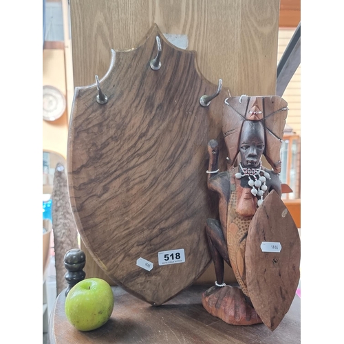 518 - Two items including a crested wooden display plaque with three metal hooks attached and a hand carve... 