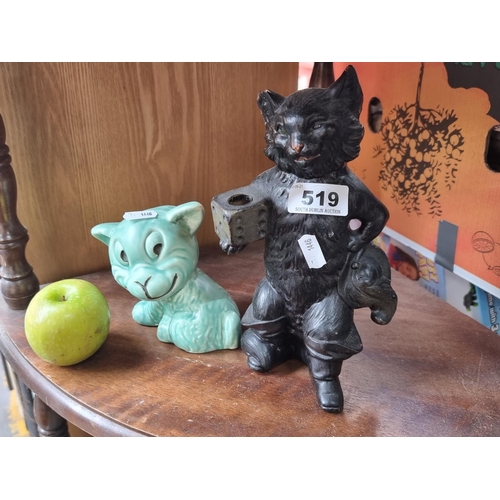 519 - A green Sylvac cat and a black puss in boots metal figure.