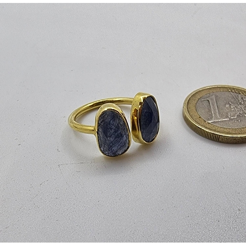 52 - A sterling silver and gold two stone sapphire ring. Weight 3g, size Q. 12 cts of natural sapphires l... 