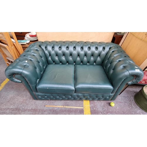 523 - A two-seat green Chesterfield leather sofa with a beautiful dark green colour and nailhead trimming ... 