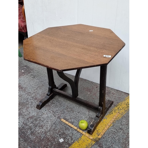 531 - An wooden octagonal table with dark wooden legs. Sturdy and in good condition.