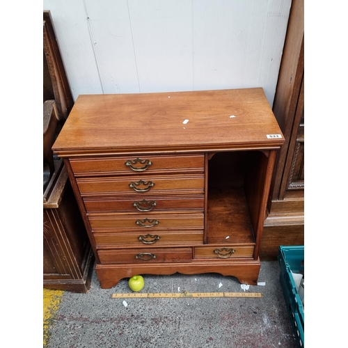 533 - An Edwardian walnut music cabinet by Henry Stone and Son Ltd of Barnbury. 7 brass handled drawers wi... 