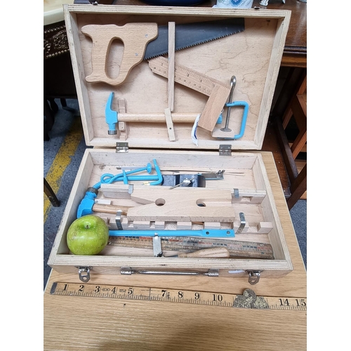 549 - A wooden child toolbox such as hammers, a vice grip and saw.