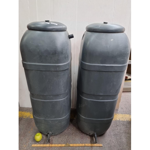 603 - Pair of green garden water butts with spouts.