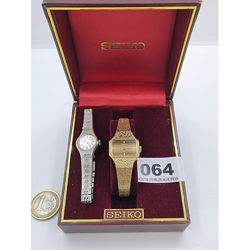 64 - A ladies Seiko cocktail watch with baton dial face and gold engine turned bracelet with safety chain... 