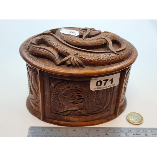 71 - A vintage highly decoratively carved Chinese Dragon cigarette box of oval form, with carvings to top... 