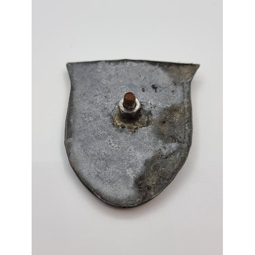 15 - A metal Nazi shield badge with an eagle mounted on a swastika depicting the name Krim with date mark... 