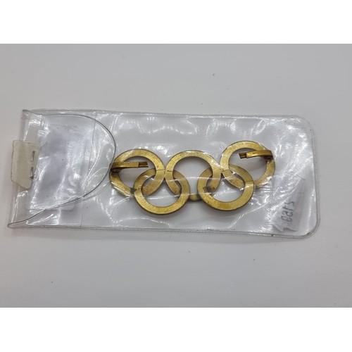 17 - A 1936 Berlin five ring Olympic design interlocking brass badge, which was attached to a ski hat.