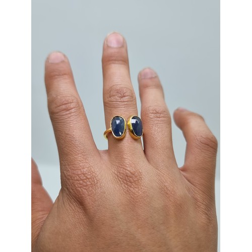 52 - A sterling silver and gold two stone sapphire ring. Weight 3g, size Q. 12 cts of natural sapphires l... 
