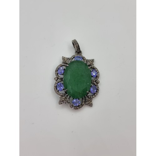 55 - Star Lot : An extremely attractive sterling silver oval shaped pendant with a fine emerald centre st... 