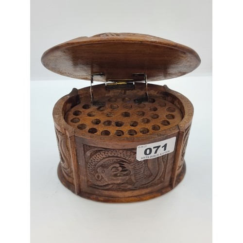 71 - A vintage highly decoratively carved Chinese Dragon cigarette box of oval form, with carvings to top... 