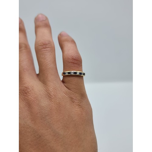 408 - A vintage 9 carat gold sapphire and diamond half eternity ring, in channel design setting. Weight 2.... 