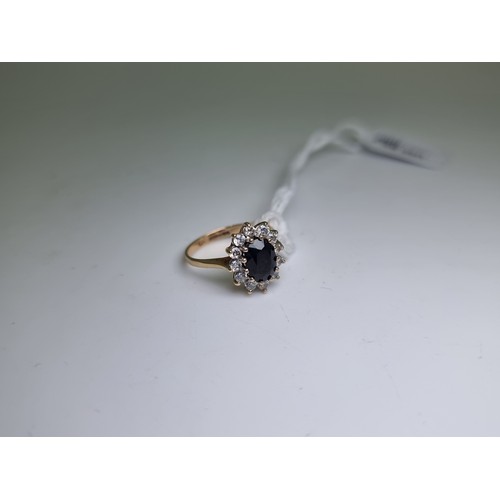 413 - A vintage 9 carat gold large sapphire cluster ring, in the Lady Diana style. Weight 2.8g, size L 1/2... 