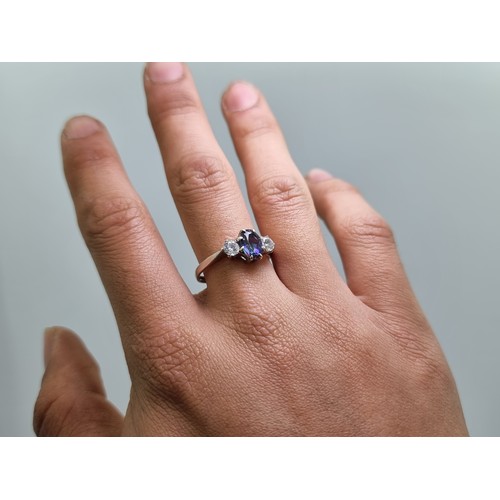 414 - A very pretty 9 carat white gold three stone tanzanite ring. Weight 3g, size Q 1/2.