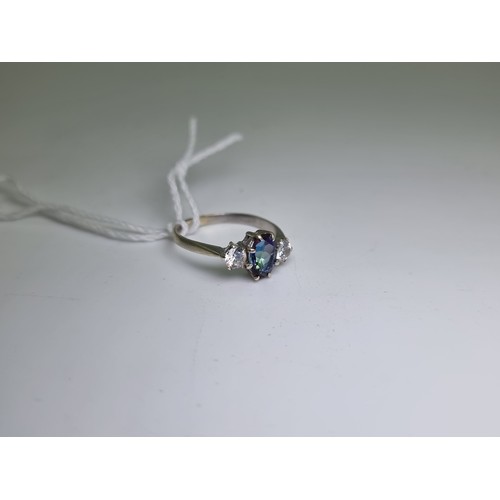 414 - A very pretty 9 carat white gold three stone tanzanite ring. Weight 3g, size Q 1/2.