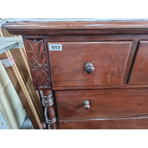 613 - Seven drawer rich mahogany bedroom chest, with floral detail and carved side pillars. Very heavy, su... 