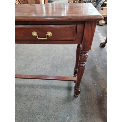 615 - Rich mahogany, two-drawer console table. With turned legs and stretcher base. Very heavy, super qual... 