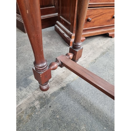 615 - Rich mahogany, two-drawer console table. With turned legs and stretcher base. Very heavy, super qual... 