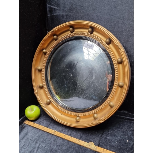 144 - A French Regency Convex Mirror, with Nice Ageing to The Glass and Cannon Ball Motif (one of which is... 