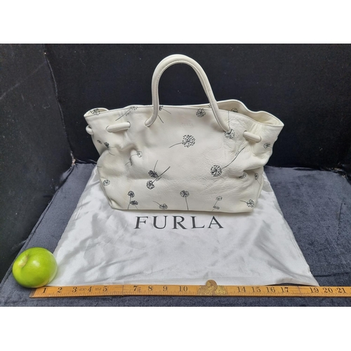 A white leather original Furla ladies designer handbag with dandelion puff pattern with original