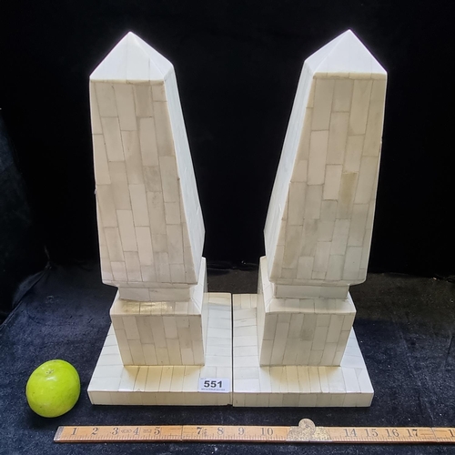 551 - A pair of classical marble effect obelisks, made in India.