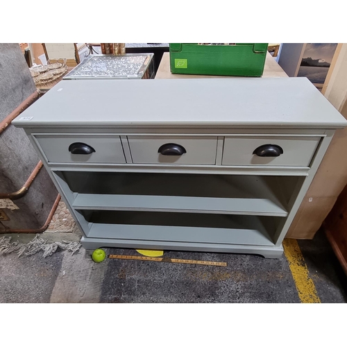 572 - Nice looking modern sideboard with 3 drawers with cup handles and storage shelves below.