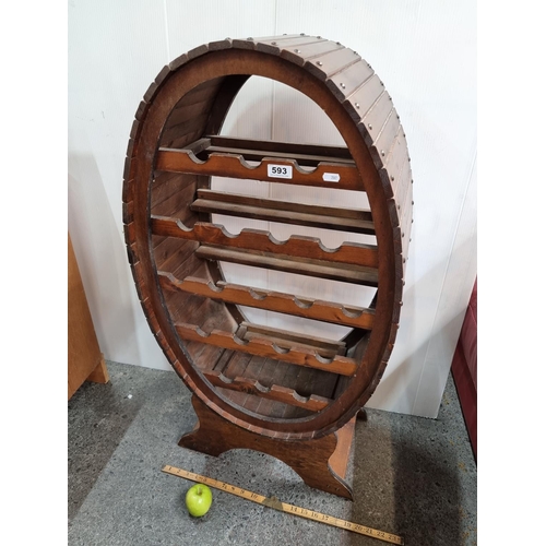 593 - A Barrel Effect Wine Rack That can Hold Up To 19 Bottles with Attractive Panelling and Stud Detail.