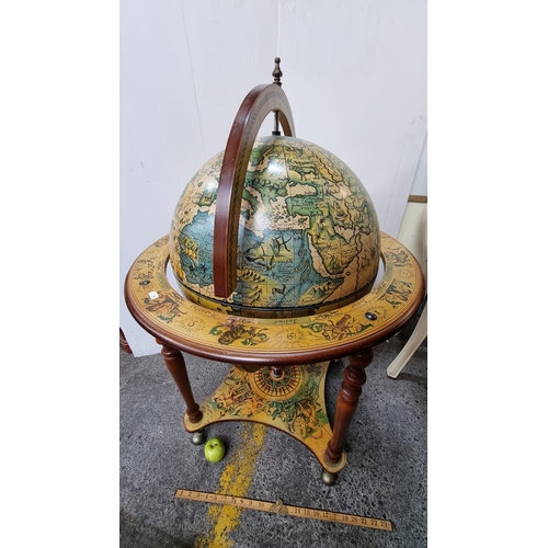 595 - An impressive large Globe Drinking Cabinet - profusely decorated with Medieval style illustration bo... 
