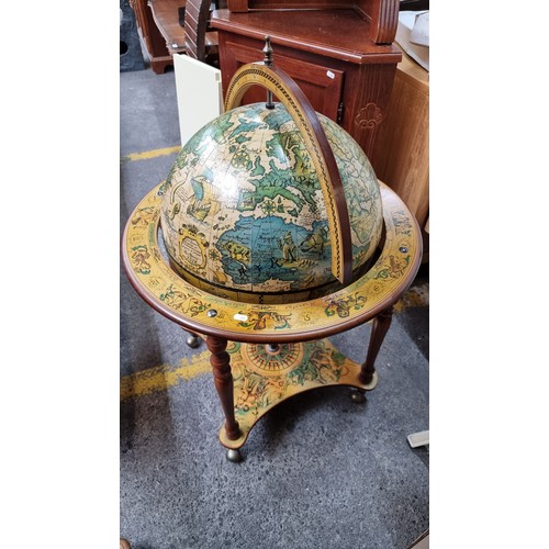 595 - An impressive large Globe Drinking Cabinet - profusely decorated with Medieval style illustration bo... 