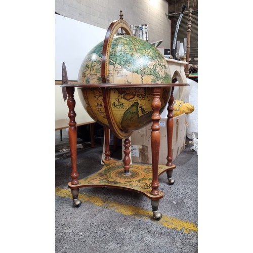 595 - An impressive large Globe Drinking Cabinet - profusely decorated with Medieval style illustration bo... 