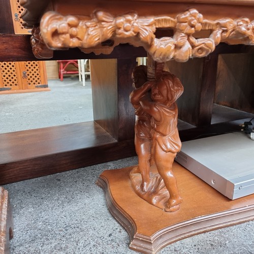 591 - A Stunning Profusely Carved Rococo Style Coffee Table with a Fitted Glass Saver Top and figural cher... 