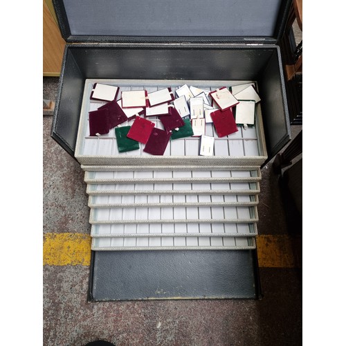 548 - A commercial jewellery vendors travel case with ten removable presentation trays and a large collect... 