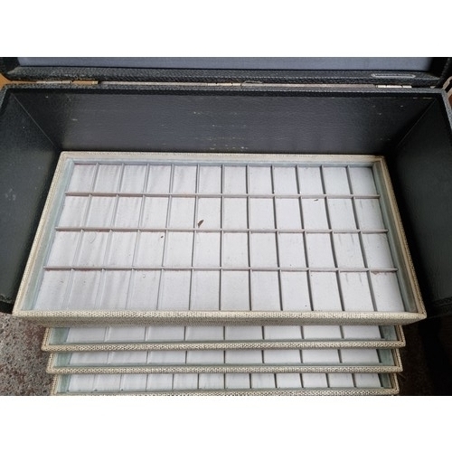 548 - A commercial jewellery vendors travel case with ten removable presentation trays and a large collect... 