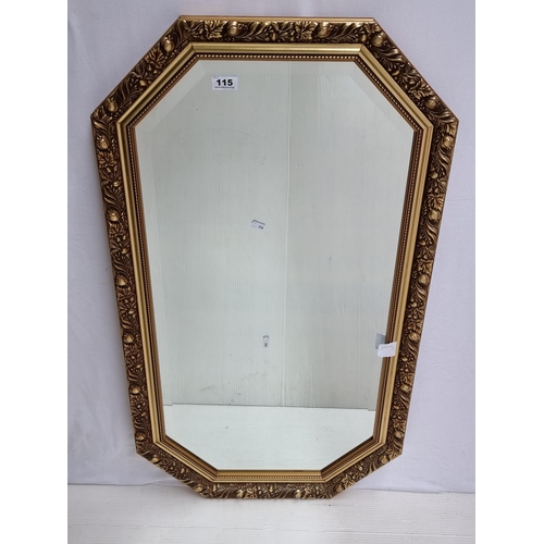 115 - Vintage octagonal bevelled glass mirror with intricately carved gilt frame. Heavy, quality item.