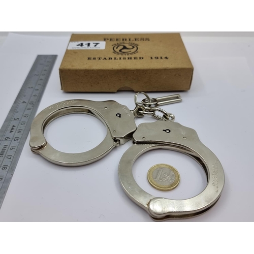 417 - A pair of 'The Peerless Handcuff Co.', Springfield, MA, USA metal handcuffs with two keys. Comes in ... 