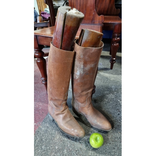 743 - A pair of tan leather women's riding boots (Approximately a size 6UK) with a pair of antique wooden ... 