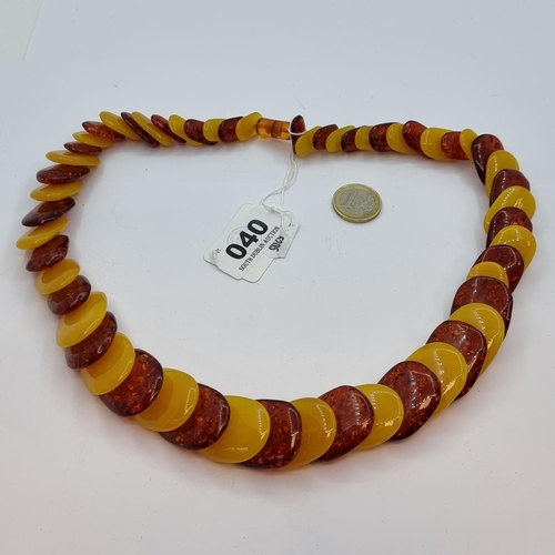 40 - A very attractive two tone graduated faux Baltic amber necklace. Length 56cm.