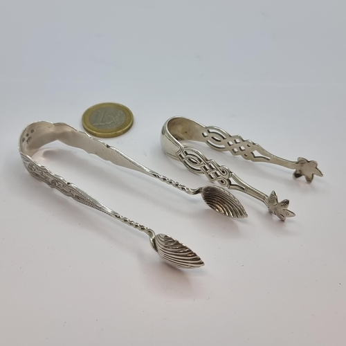5 - Two sterling silver sugar nips, the first intricately decorated in Celtic design. Hallmarked Birming... 
