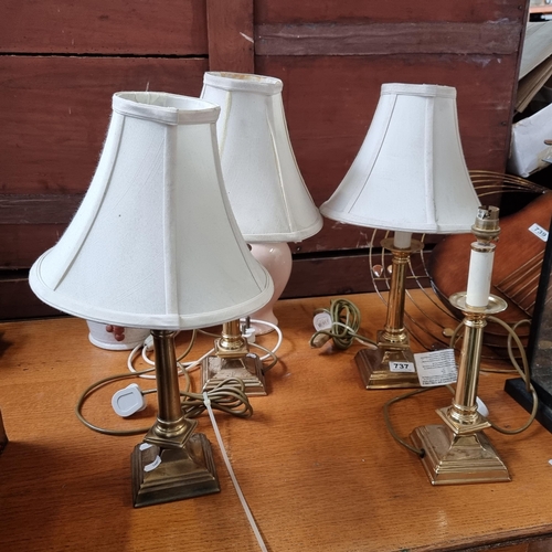 737 - Four matching brass table lamps, three with white shades.