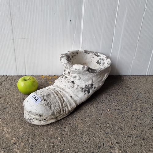 742 - A large very heavy  concrete shoe planter painted white.