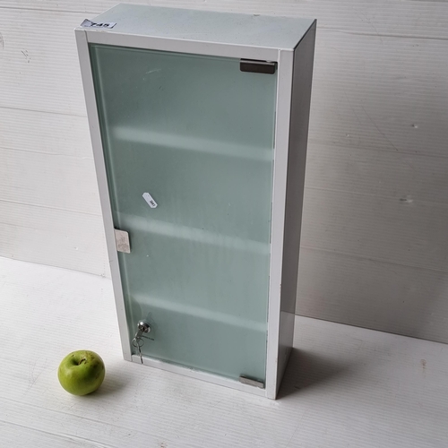 745 - A tempered glass fronted lock and bolt cabinet with key.