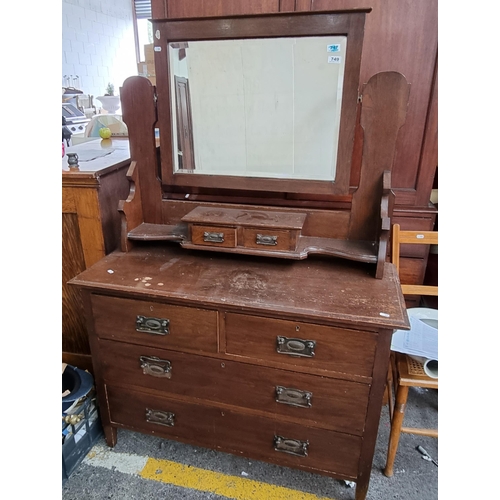 749 - A large dressing table with a beveled mirror and six drawers, a lovely carved shape. Measuring H: 15... 