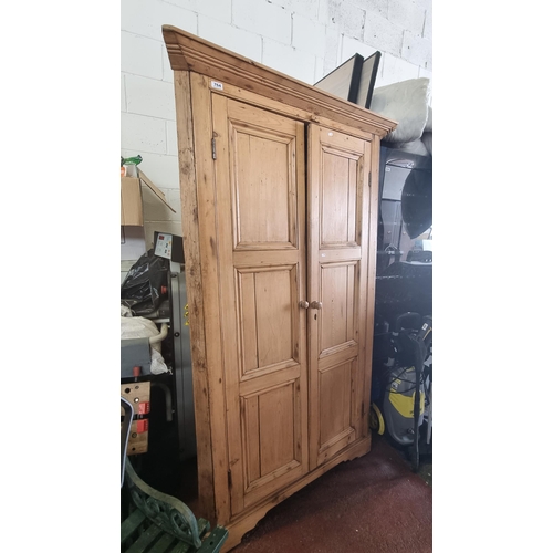 764 - A rustic pitch pine corner cabinet with shelving within. Needs to be secured to corner. Nice old pie... 