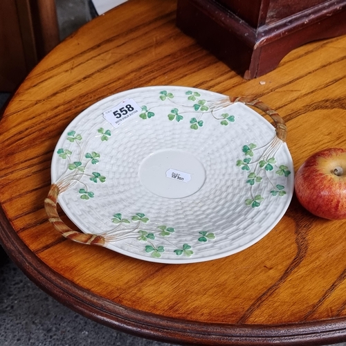 558 - A black mark  Belleek shamrock pattern decorative plate with lovely basket weave texture design.