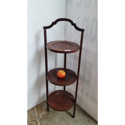 565 - A three tier vintage wooden collapsible circular plant stand with string inlay design. An elegant pi... 