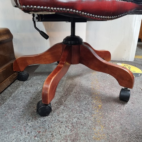 467 - Star Lot: Vintage leather swivel button-back captain's chair in oxblood.