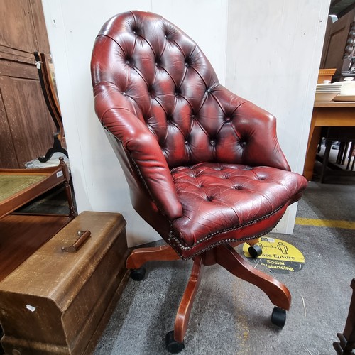 467 - Star Lot: Vintage leather swivel button-back captain's chair in oxblood.